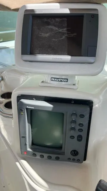 Slide: The Image of Navigation equipment on a 1997 Sea Ray 400 boat, featuring Garmin and Raytheon displays. - 8