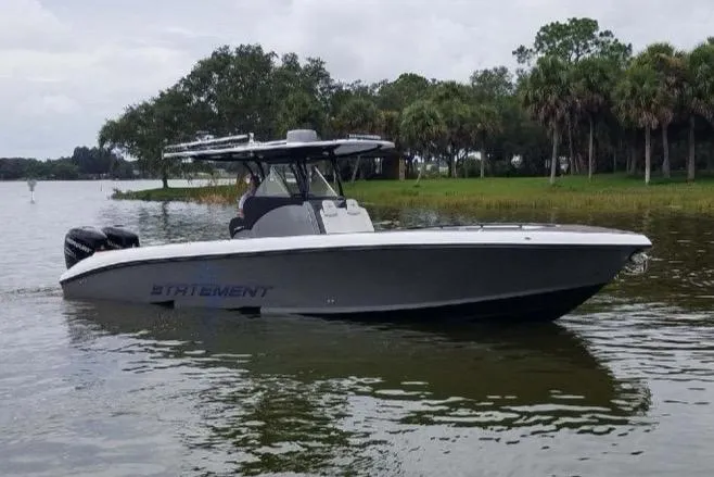 The Image of 2019 Statement 350 Open boat on a calm lake with trees in the background. - 0