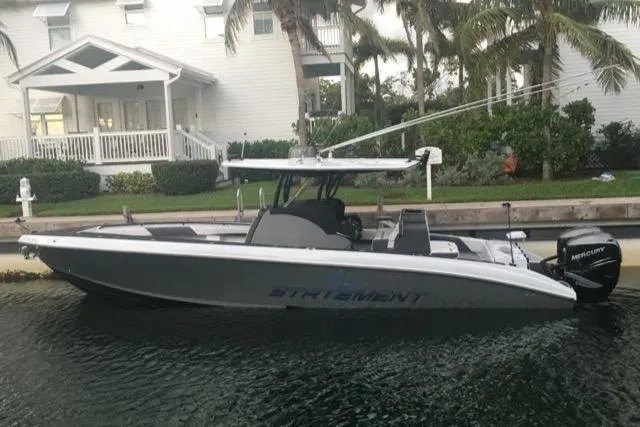 Slide: The Image of 2019 Statement 350 Open boat docked near a waterfront house. - 1