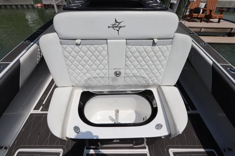 Slide: The Image of 2019 Statement 350 Open boat with white quilted seating and built-in storage compartment. - 11