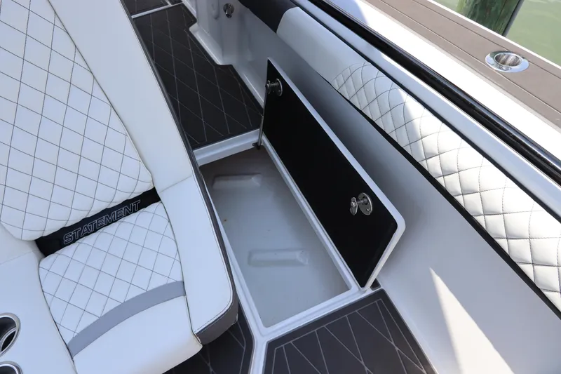 Slide: The Image of 2019 Statement 350 Open boat interior with white quilted seats and storage compartment. - 15