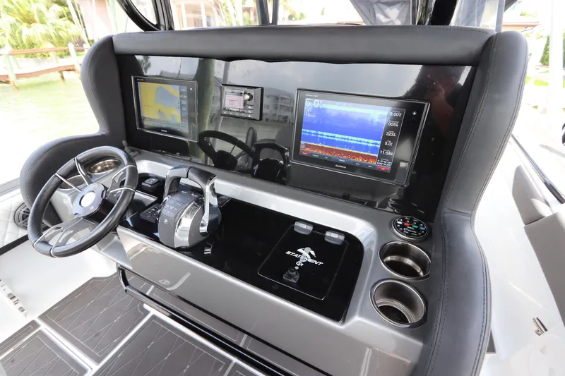 Slide: The Image of Control panel of a 2019 Statement 350 Open boat with navigation screens and steering wheel. - 24