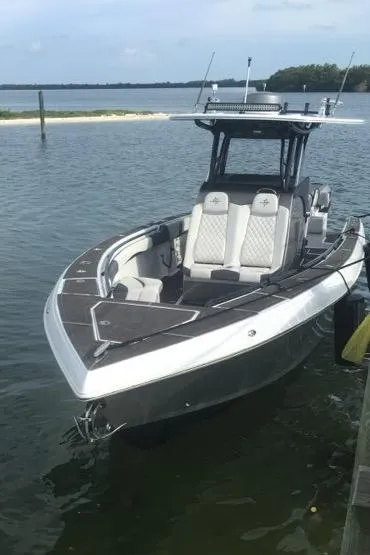 Slide: The Image of 2019 Statement 350 Open boat docked on calm water. - 3