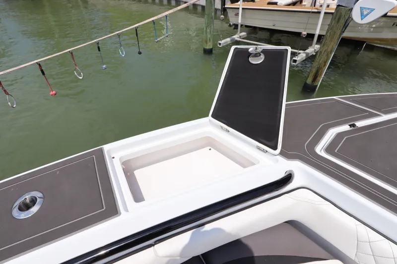 Slide: The Image of Open storage compartment on a 2019 Statement 350 Open boat docked by the water. - 34