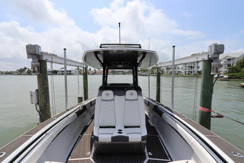 Slide: The Image of 2019 Statement 350 Open boat docked at a marina with waterfront view. - 37