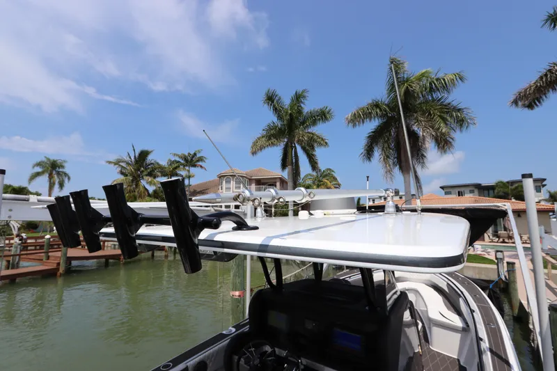 Slide: The Image of 2019 Statement 350 Open boat docked near palm trees and waterfront homes. - 39