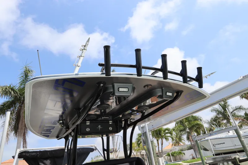 Slide: The Image of 2019 Statement 350 Open boat with rod holders and electronics under a clear sky. - 43