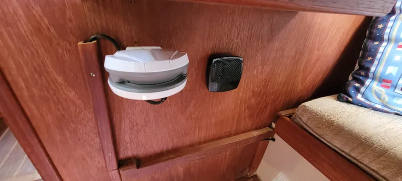 Slide: The Image of Interior of 1986 Island Packet 27 Sloop with wooden paneling and electronic devices. - 13