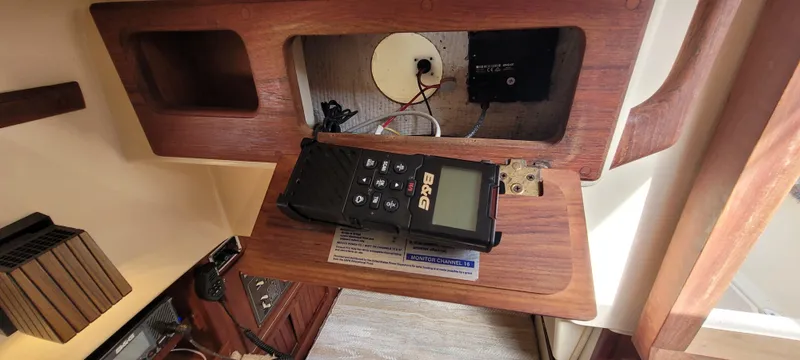 Slide: The Image of Interior of 1986 Island Packet 27 Sloop with navigation equipment and wooden cabinetry. - 19