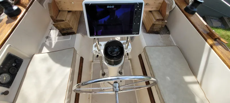 Slide: The Image of Cockpit of 1986 Island Packet 27 Sloop with steering wheel and navigation equipment. - 30