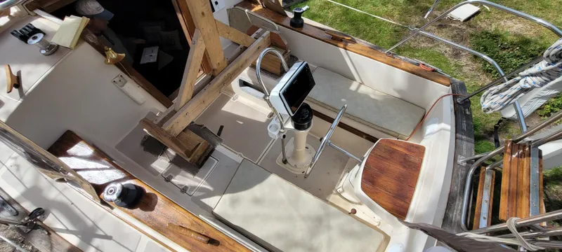 Slide: The Image of 1986 Island Packet 27 Sloop cockpit with steering wheel and navigation equipment. - 31