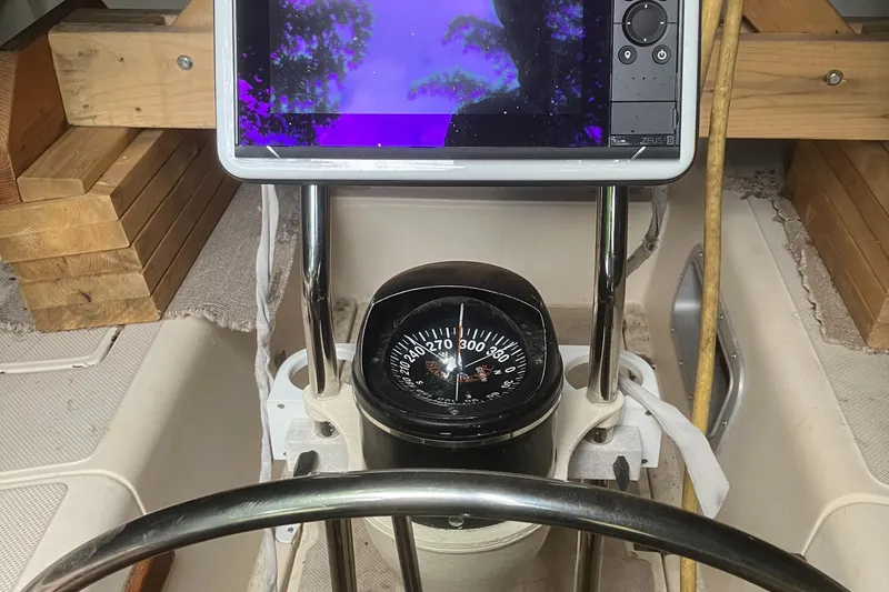 Slide: The Image of Steering console of 1986 Island Packet 27 Sloop with compass and navigation display. - 32