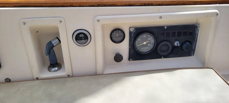 Slide: The Image of Control panel of a 1986 Island Packet 27 Sloop, featuring gauges and switches. - 35