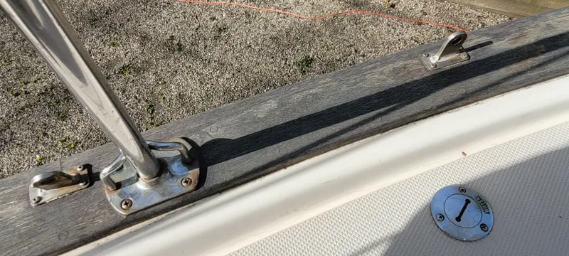 Slide: The Image of 1986 Island Packet 27 Sloop deck detail with metal fittings and textured surface. - 42