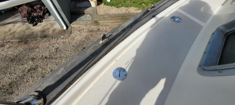 Slide: The Image of 1986 Island Packet 27 Sloop deck with fittings and textured surface. - 43
