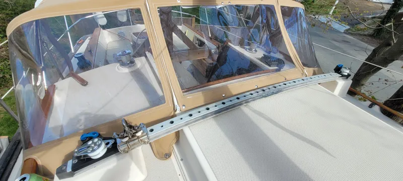 Slide: The Image of 1986 Island Packet 27 Sloop with tan canvas and clear windows on deck. - 45