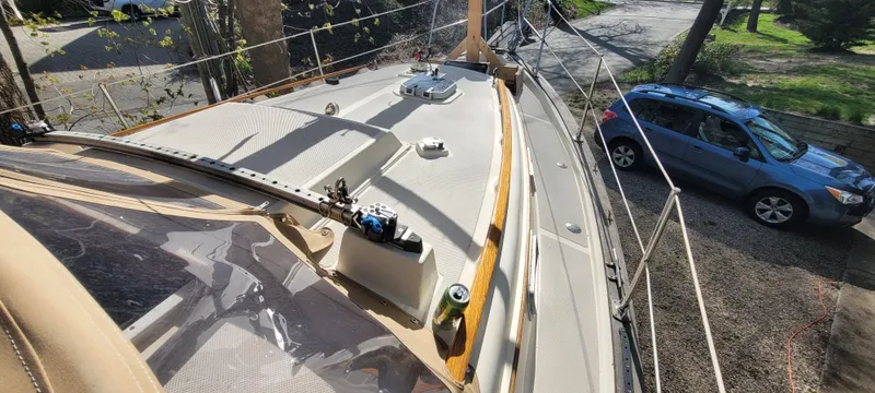Slide: The Image of 1986 Island Packet 27 Sloop sailboat deck view with parked car nearby. - 46