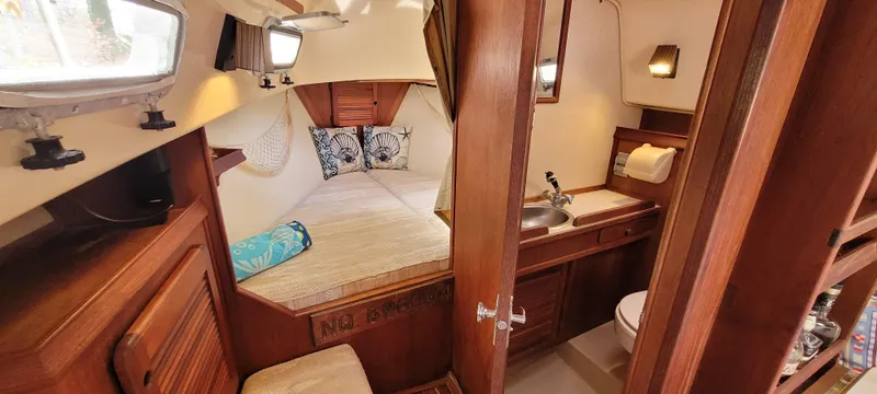 Slide: The Image of Cozy interior of 1986 Island Packet 27 Sloop with bed and compact bathroom. - 7
