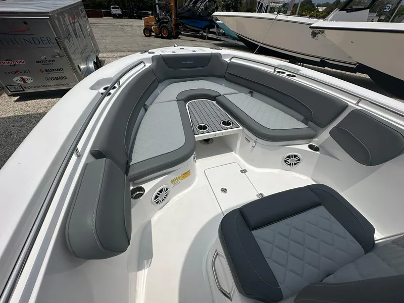 Slide: The Image of 2024 NauticStar 252 boat interior with gray seating and cup holders. - 10