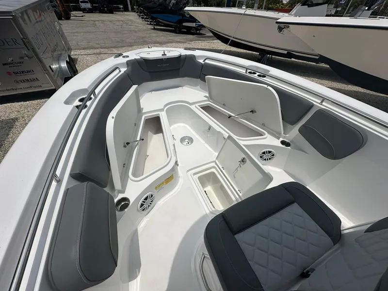 Slide: The Image of 2024 NauticStar 252 boat interior with open storage compartments and seating. - 13