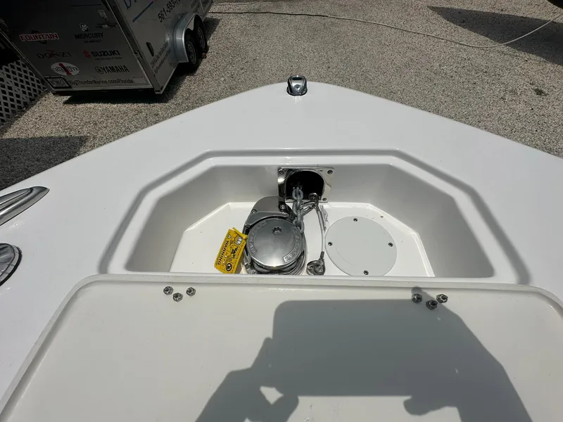 Slide: The Image of 2024 NauticStar 252 boat anchor compartment with winch and storage. - 14