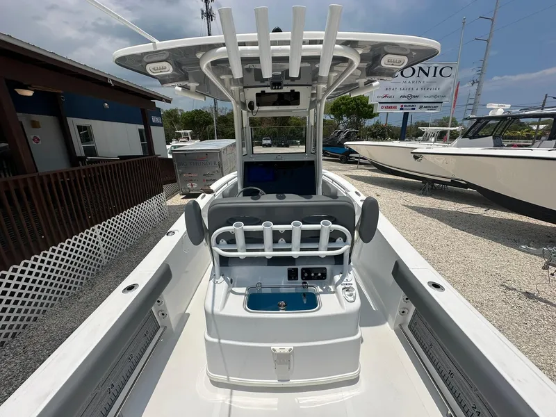 Slide: The Image of 2024 NauticStar 252 center console boat with rod holders and control panel. - 15