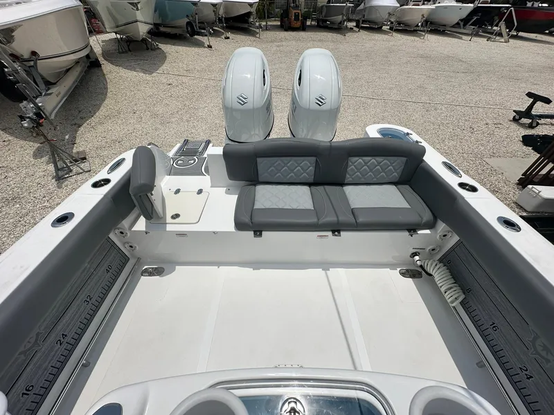 Slide: The Image of 2024 NauticStar 252 boat interior with dual engines and cushioned seating. - 18