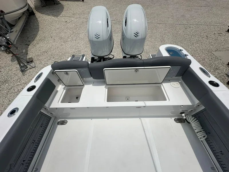 Slide: The Image of 2024 NauticStar 252 boat with dual outboard engines and spacious storage compartments. - 20