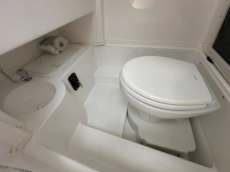 Slide: The Image of 2024 NauticStar 252 boat bathroom with toilet and sink - 21