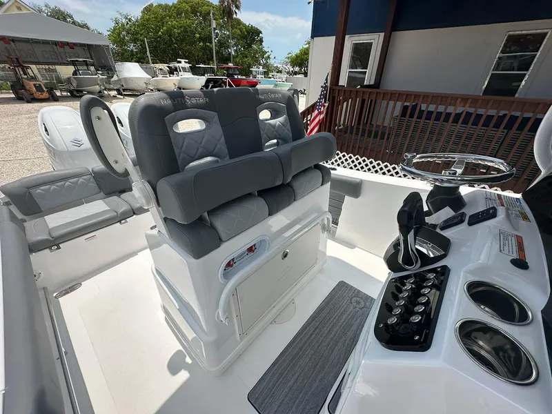 Slide: The Image of 2024 NauticStar 252 boat interior with dual captain's chairs and control console. - 4