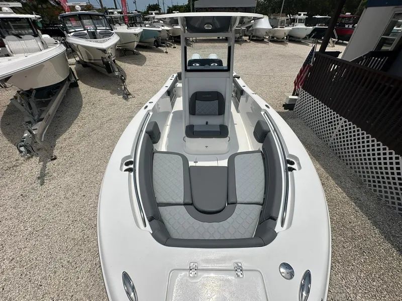 Slide: The Image of 2024 NauticStar 252 boat with spacious seating and modern design in a boatyard. - 6
