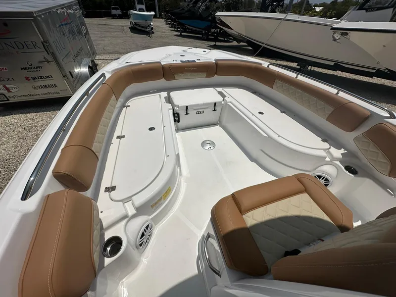 Slide: The Image of 2024 NauticStar 251 boat interior with tan and white seating. - 12