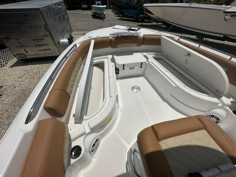 Slide: The Image of 2024 NauticStar 251 boat interior with tan seating and storage compartments. - 14