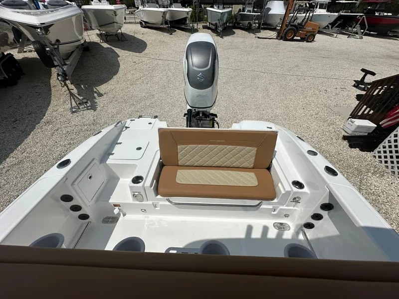 Slide: The Image of 2024 NauticStar 251 boat with tan seating and outboard motor. - 20
