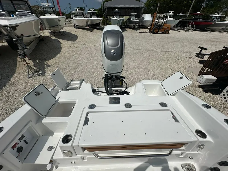Slide: The Image of 2024 NauticStar 251 boat with outboard motor and open storage compartments. - 22