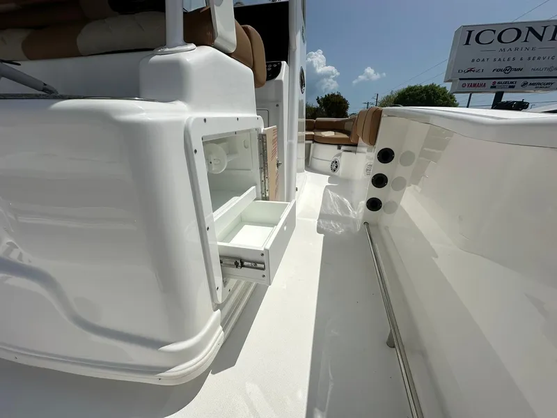 Slide: The Image of 2024 NauticStar 251 boat interior with open storage compartment. - 23