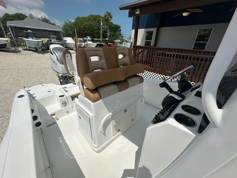 Slide: The Image of 2024 NauticStar 251 boat interior with dual captain's chairs and control console. - 3