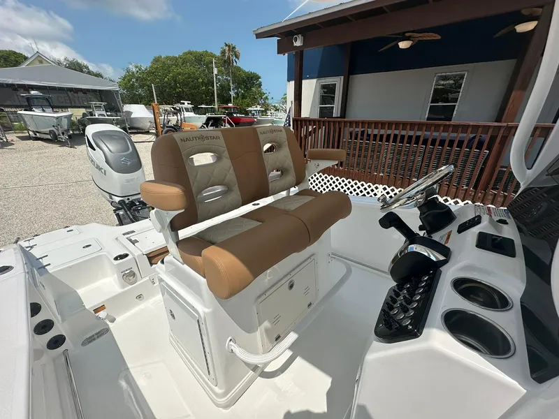 Slide: The Image of 2024 NauticStar 251 boat cockpit with dual captain's chairs and control console. - 5
