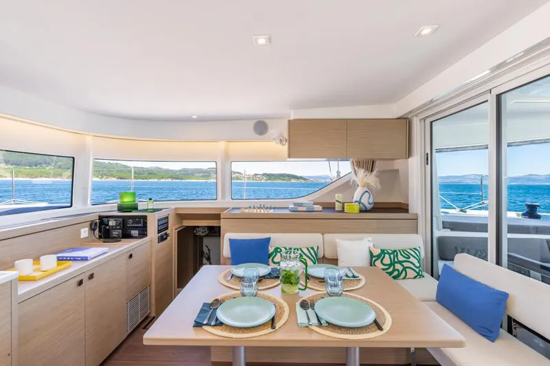 Slide: The Image of Luxurious interior of 2025 Lagoon 43 yacht with elegant dining setup and ocean view. - 16