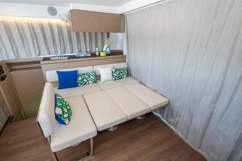 Slide: The Image of Modern interior of 2025 Lagoon 43 yacht with stylish seating and decorative pillows. - 20