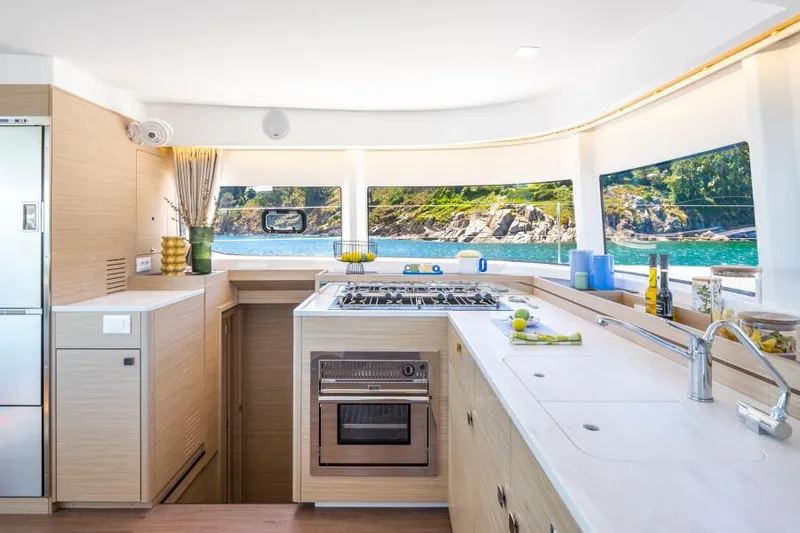 Slide: The Image of Modern kitchen interior of 2025 Lagoon 43 yacht with scenic ocean view. - 21