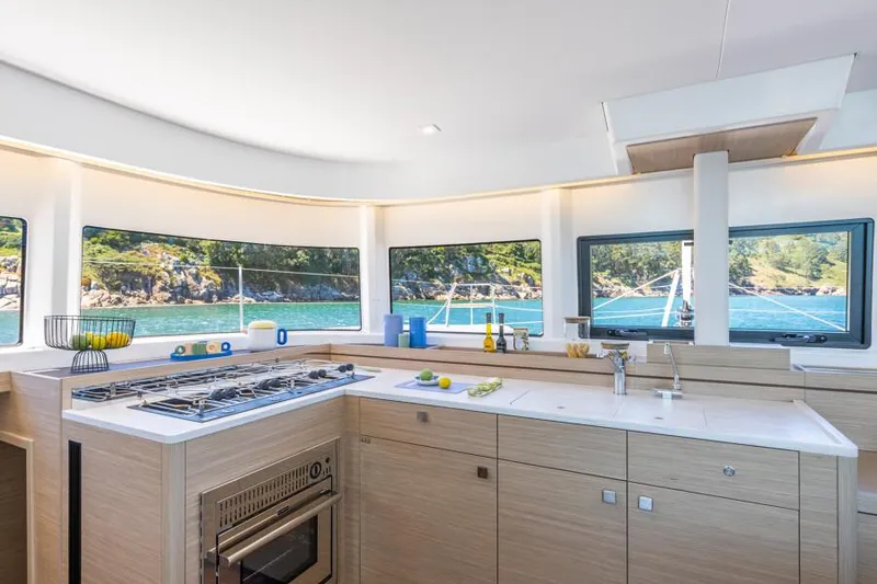 Slide: The Image of Modern kitchen interior of 2025 Lagoon 43 yacht with scenic ocean view. - 22