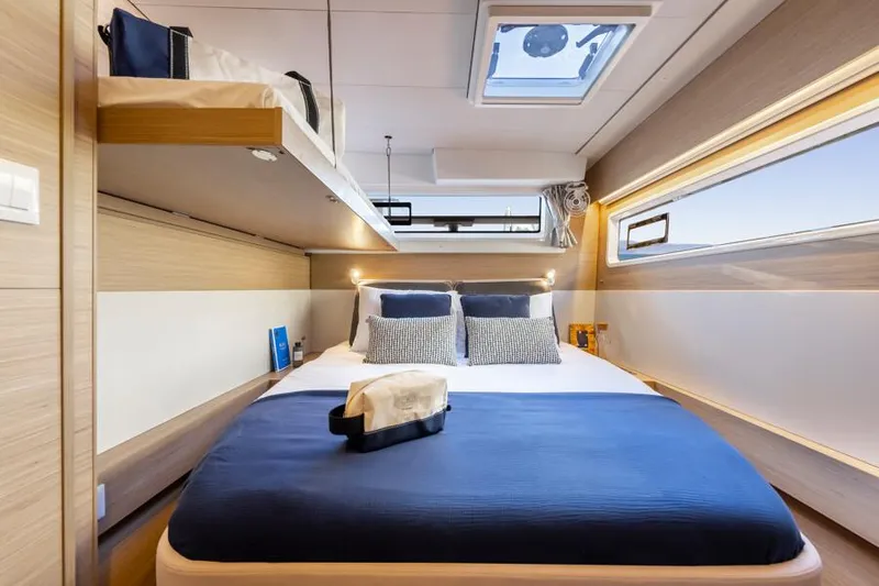 Slide: The Image of Luxurious cabin interior of 2025 Lagoon 43 yacht with modern bedding and natural light. - 26