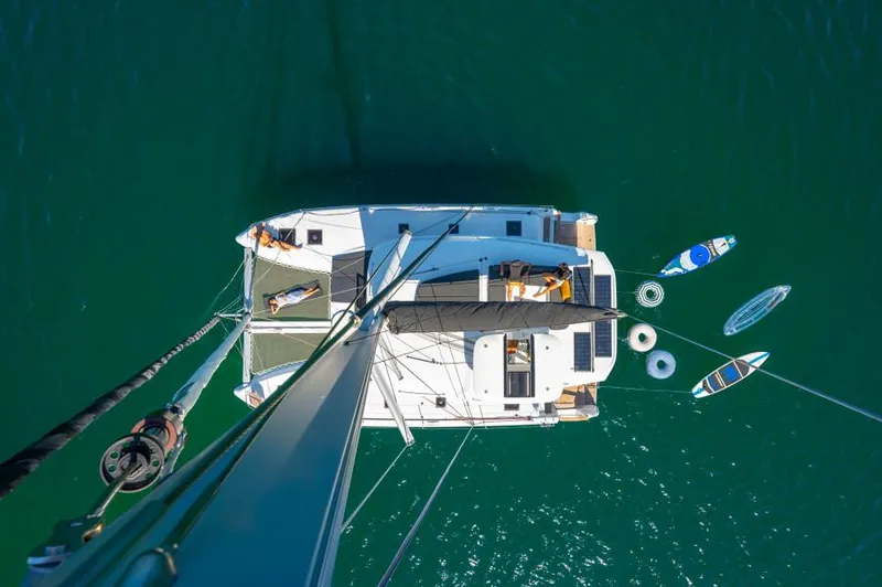 Slide: The Image of Aerial view of 2025 Lagoon 43 catamaran with paddleboards and kayaks in the water. - 7