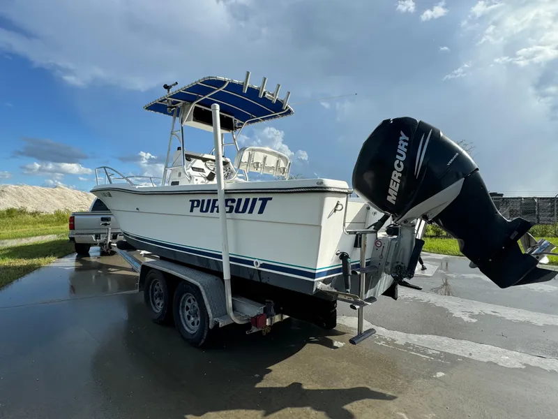 Slide: The Image of 1989 Pursuit 230 Center Console boat on trailer with Mercury outboard motor. - 2