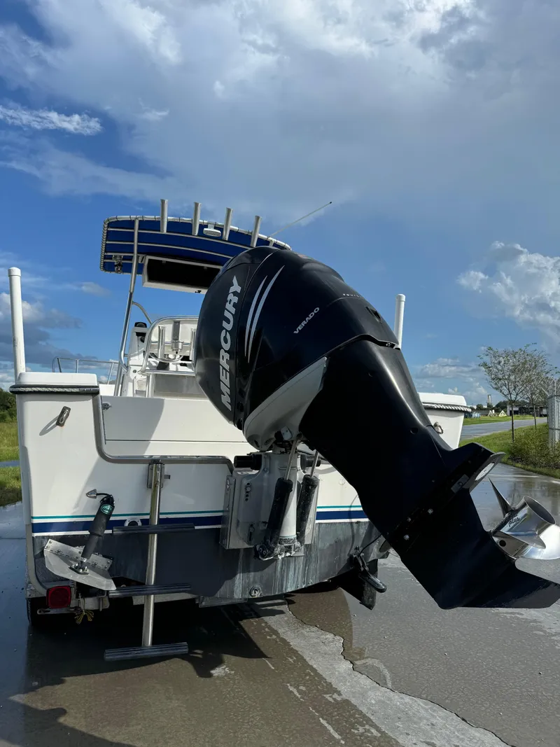 Slide: The Image of 1989 Pursuit 230 Center Console boat with Mercury outboard motor on a sunny day. - 3
