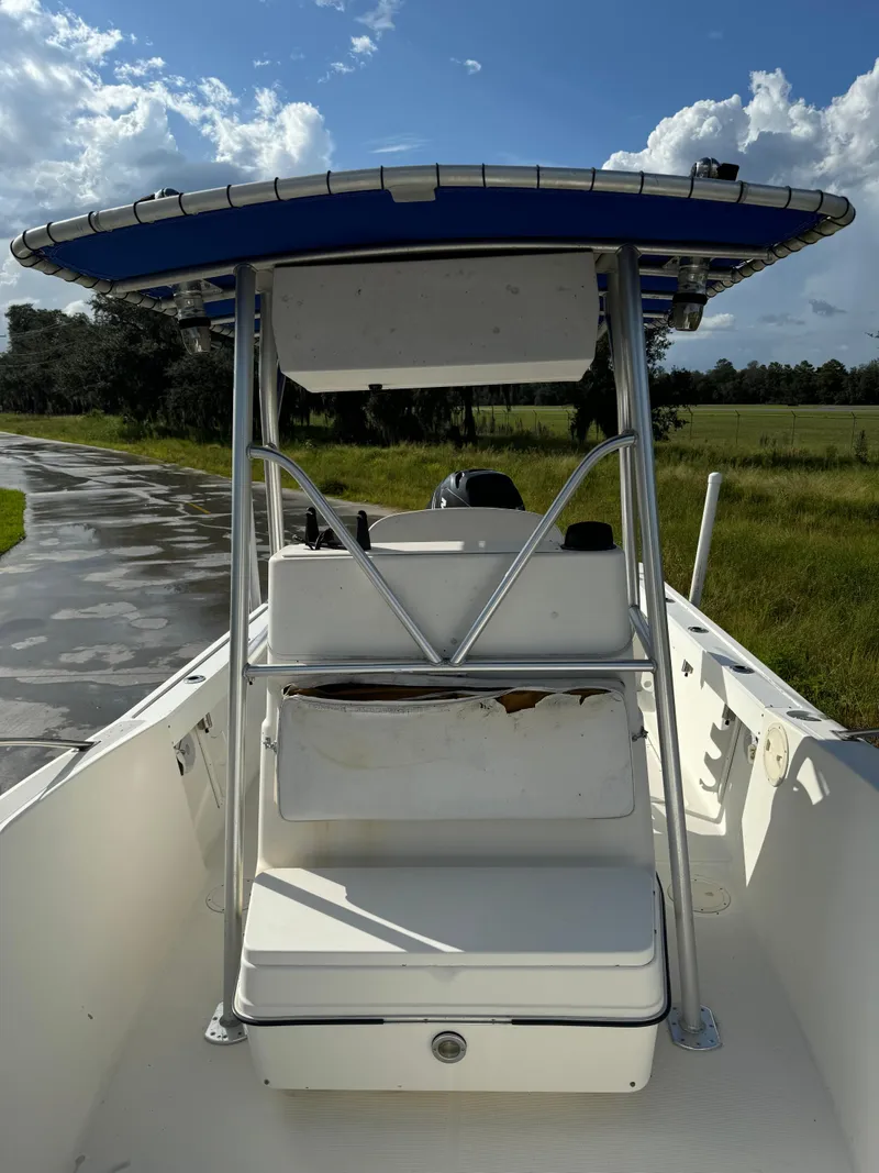 Slide: The Image of 1989 Pursuit 230 Center Console boat with blue canopy on a sunny day. - 6