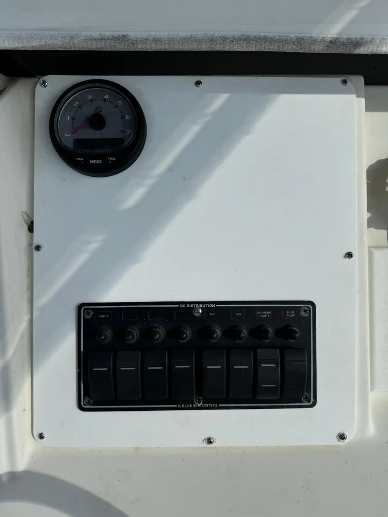 Slide: The Image of 1989 Pursuit 230 Center Console dashboard with gauge and switch panel. - 9