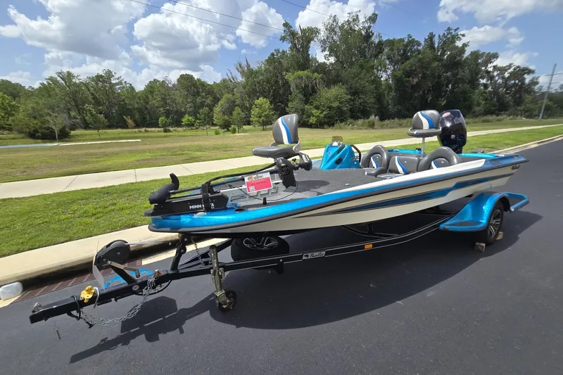 Slide: The Image of 2024 Bass Cat Bobcat Vision boat on trailer, parked on a sunny day. - 6