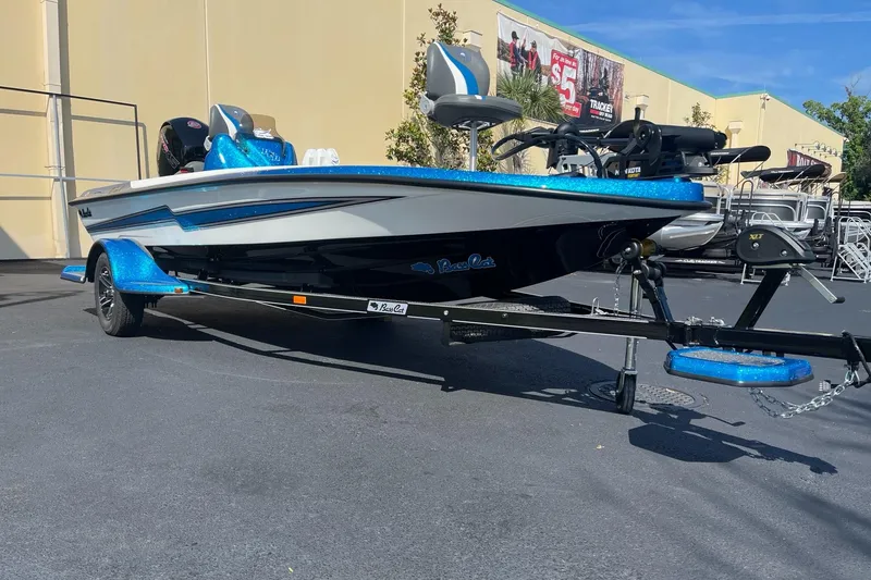 Slide: The Image of 2024 Bass Cat Bobcat Vision boat on trailer, blue and white color scheme. - 2